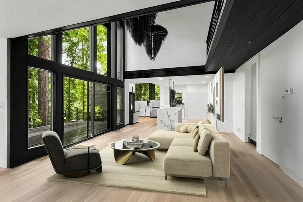 The sun drenched open concept main level is ideal for entertaining and family life alike. Flexible layout allows for multiple options for use of space, enjoy threes story height windows, sunset views, stunning bespoke chandeliers, gorgeous chefs kitchen with large island with seating for 8, dinning space with seating for 12, an oversized deck with plumbing and gas hook up, gorgeous wide plank hardwood floors and a wood burning fireplace.