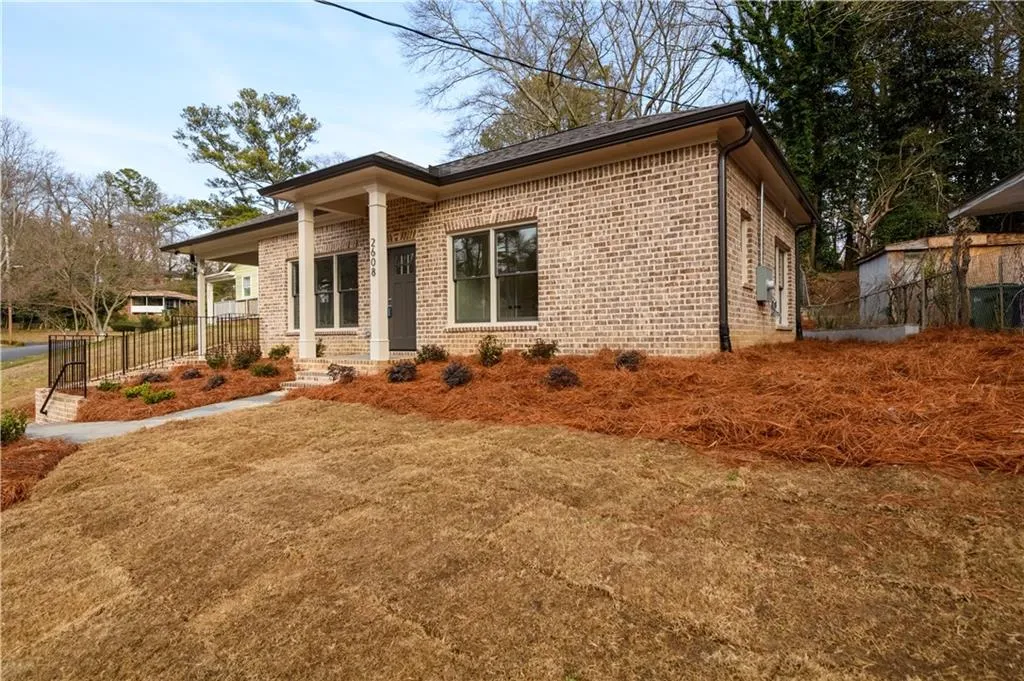 View of front of house with covered porch and brick siding