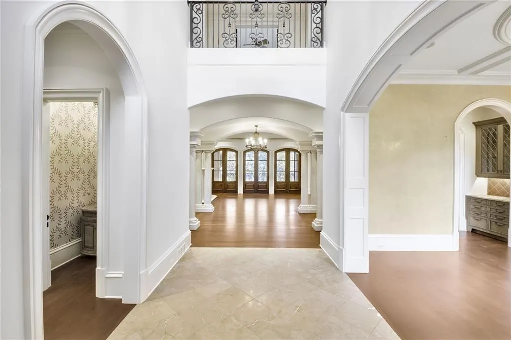 Two-story entry foyer flanked by a living area and formal dining room with butler's pantry Two-story entry foyer flanked by a living area and formal dining room with butler's pantry