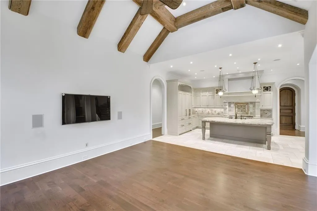 This keeping/great room with exposed beams is perfect for large gatherings This keeping/great room with exposed beams is perfect for large gatherings