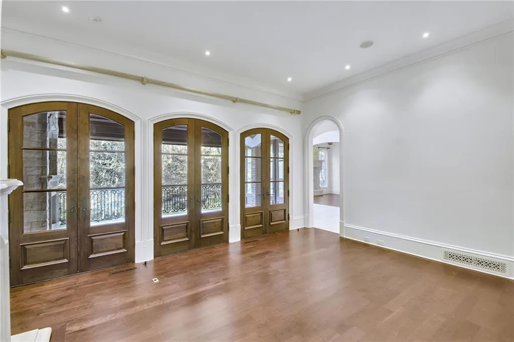 Living room with triple, arched doors provides direct access to one of the covered balconys Living room with triple, arched doors provides direct access to one of the covered balconys