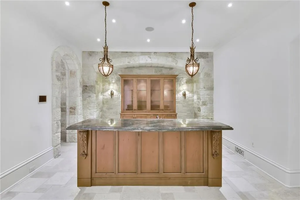 Thoughtful bar with glass-front cabinet and pendent lighting Thoughtful bar with glass-front cabinet and pendent lighting