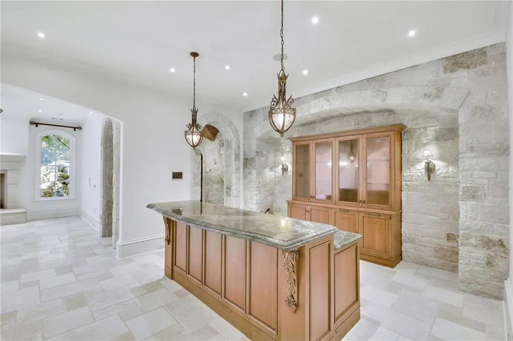 Stone wall and high ceilings with recessed lighting Stone wall and high ceilings with recessed lighting