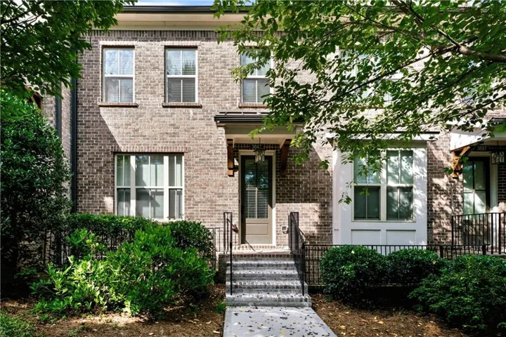 Handsome brick front townhome along a lovely shaded street with wide sidewalks and a short stroll to the amenities and Suwanee Jublilee shops and eateries