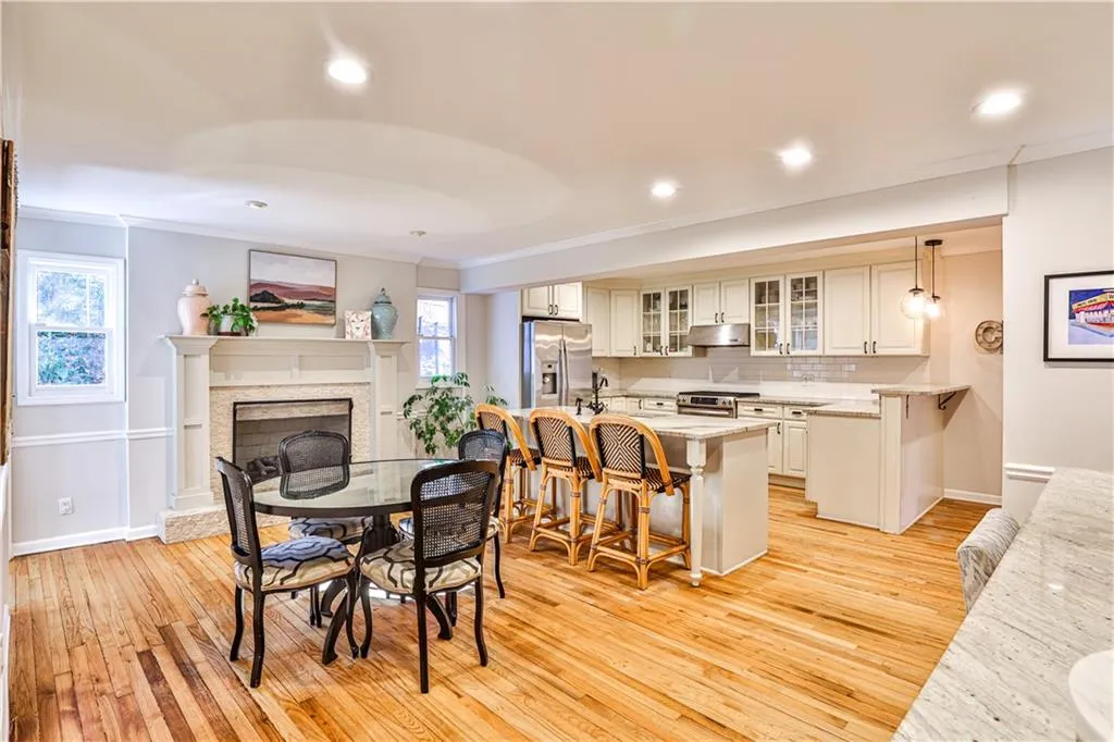 Dining space with crown molding and light hardwood / wood-style flooring