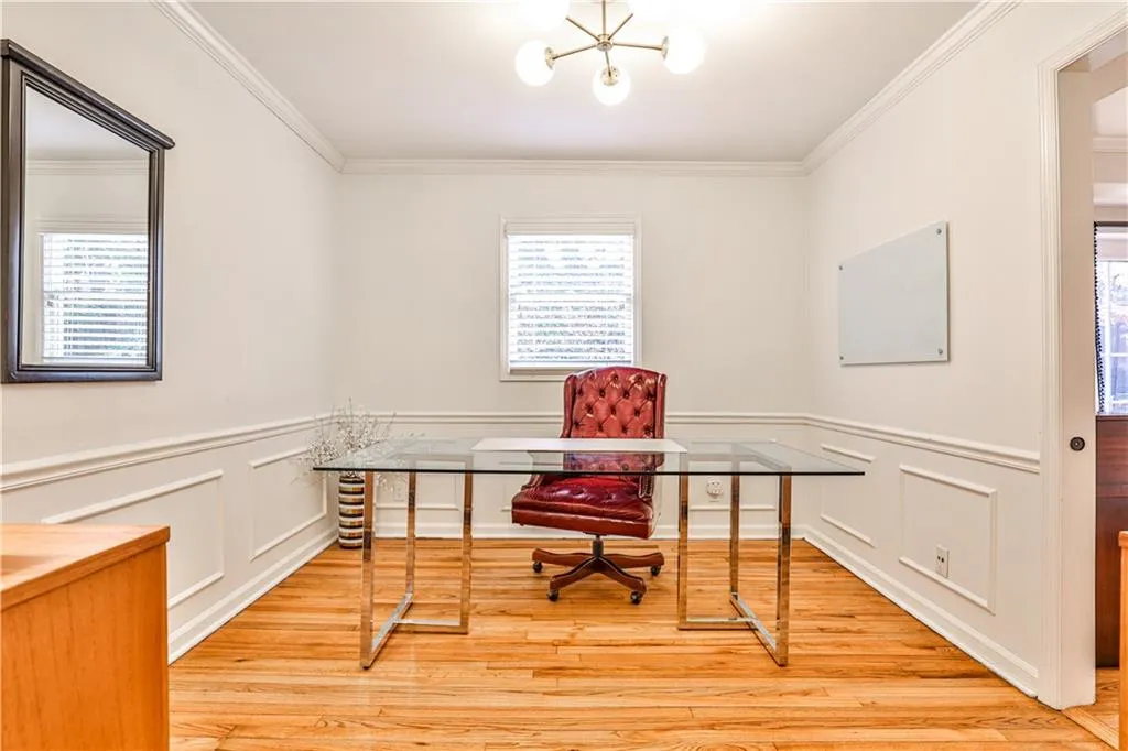 Office featuring crown molding, light hardwood / wood-style floors, and a wealth of natural light
