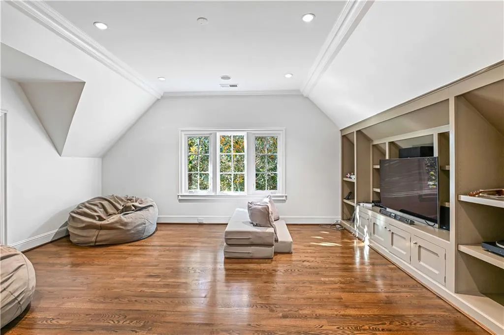 Top floor sitting area with built in cabinetry