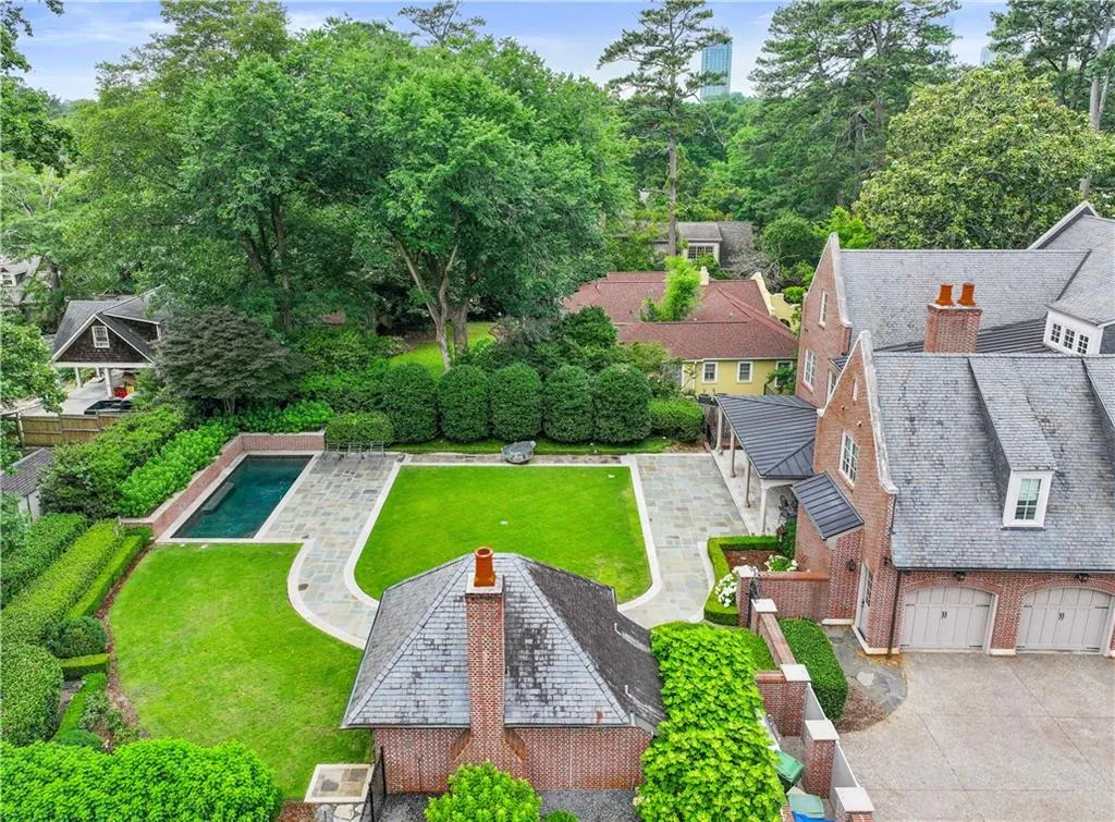 Expansive exterior featuring a brick facade, slate roofing, and multiple gables
