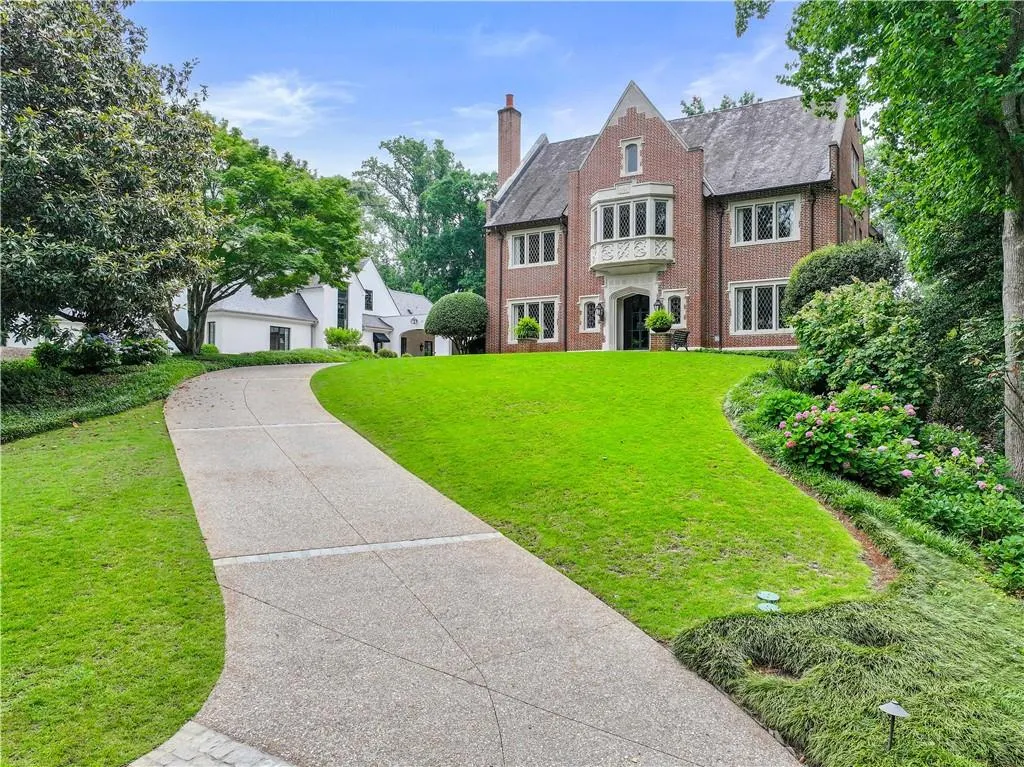 Brick exterior residence featuring a gabled roofline and multiple windows with muntins
