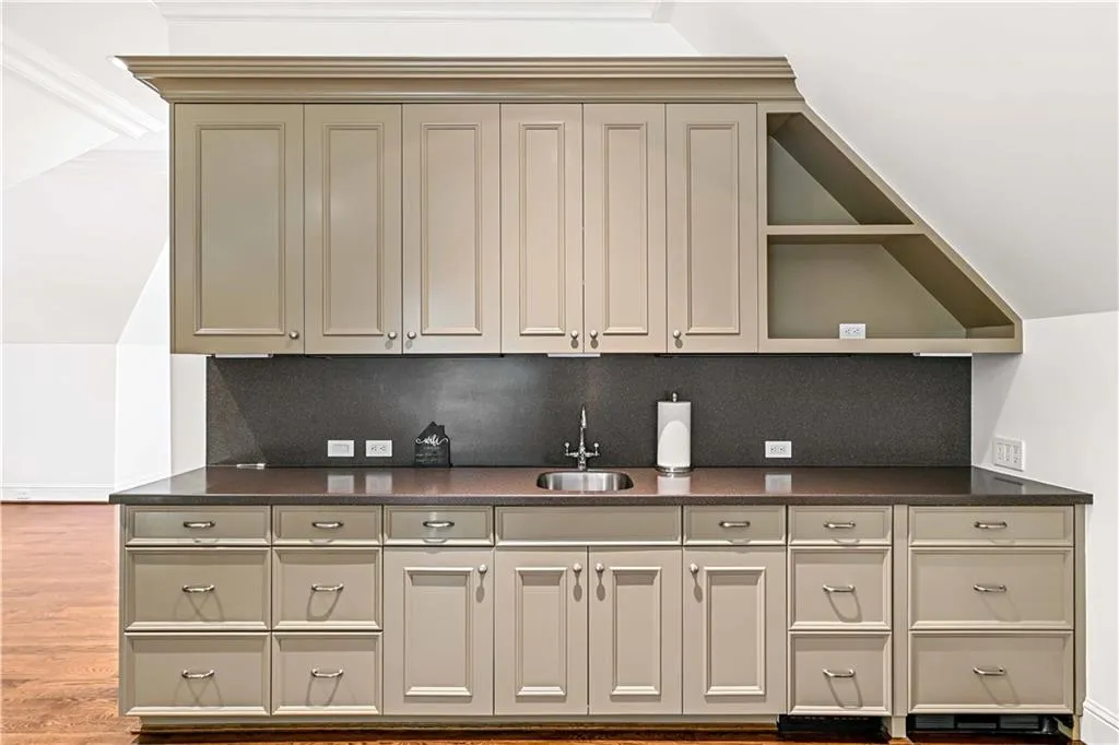 Top floor area with fridge, sink, and plenty of storage