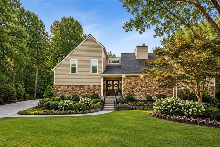 This photo has been virtually enhanced to showcase new landscaping and a new front door.