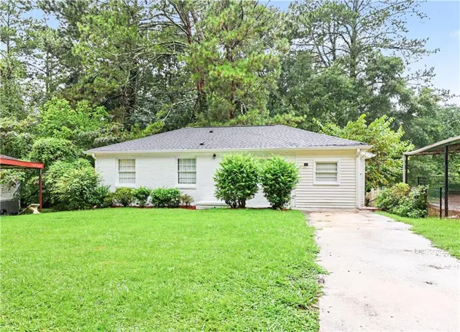 Charming single-story home featuring a clean-lined exterior with horizontal siding and a gently sloped roof