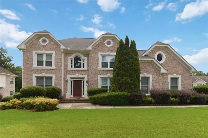 Two-story brick exterior with white trim details