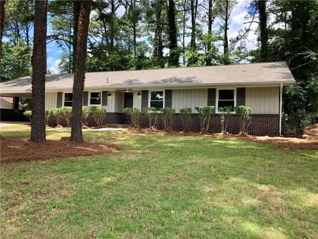 Ranch with well manicured front yard.