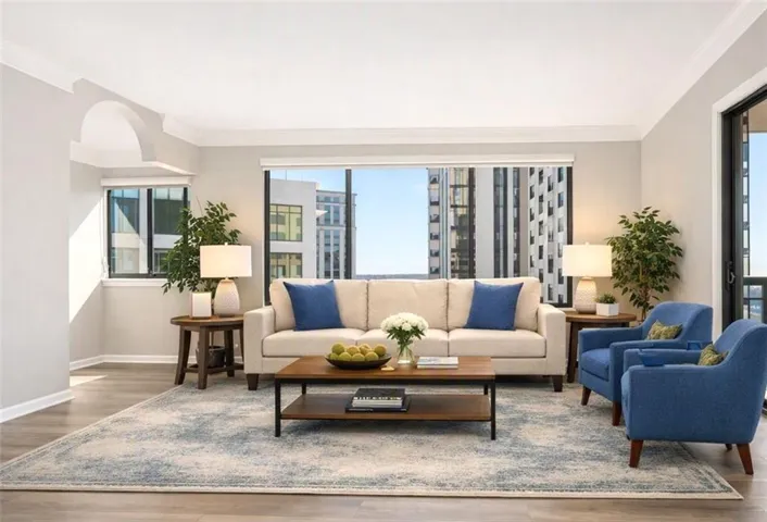 Spacious family room and dining area. Two balconies, new flooring, fresh paint, BRAND new HVAC system.-Virtually Staged