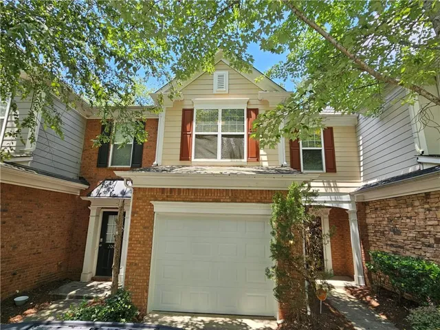 Multi-level townhome exterior featuring brick and siding finishes