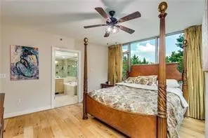 large master bedroom with floor to ceiling panoramic  window views