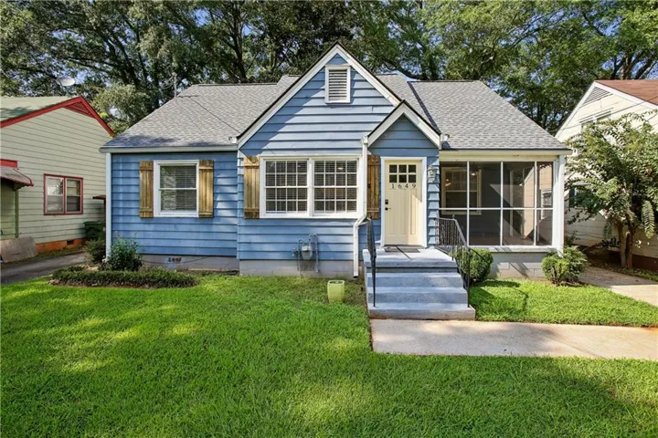 Blue siding exterior with a light grey shingle roof