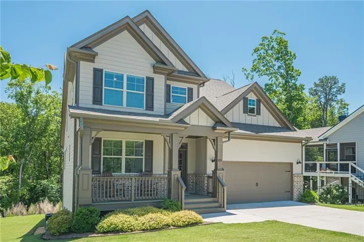 Two-story exterior with multi-toned siding and dark shutters