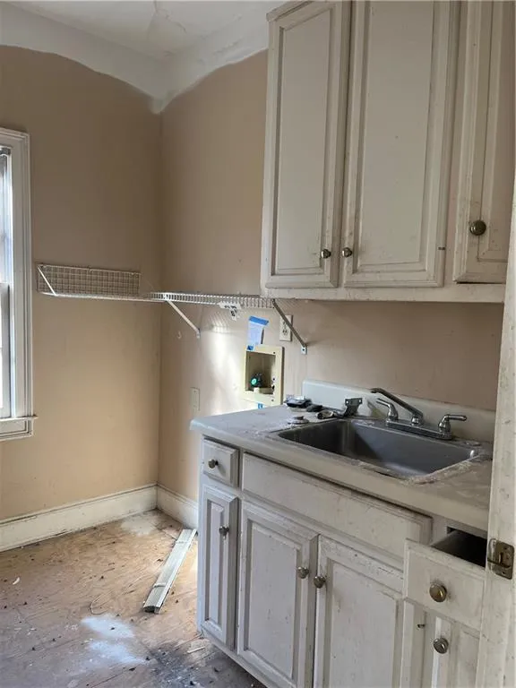 Laundry room featuring cabinets, hookup for a washing machine, and sink