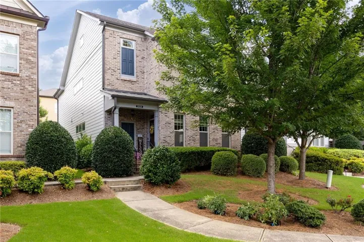 Brick facade residential property featuring a covered porch entrance