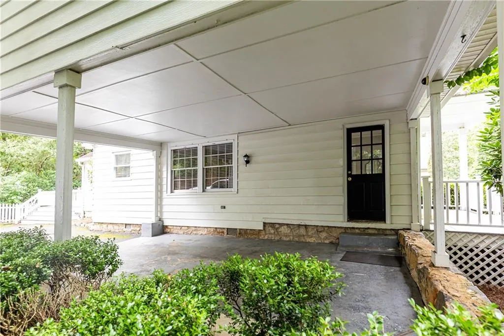 Doorway to property featuring covered porch