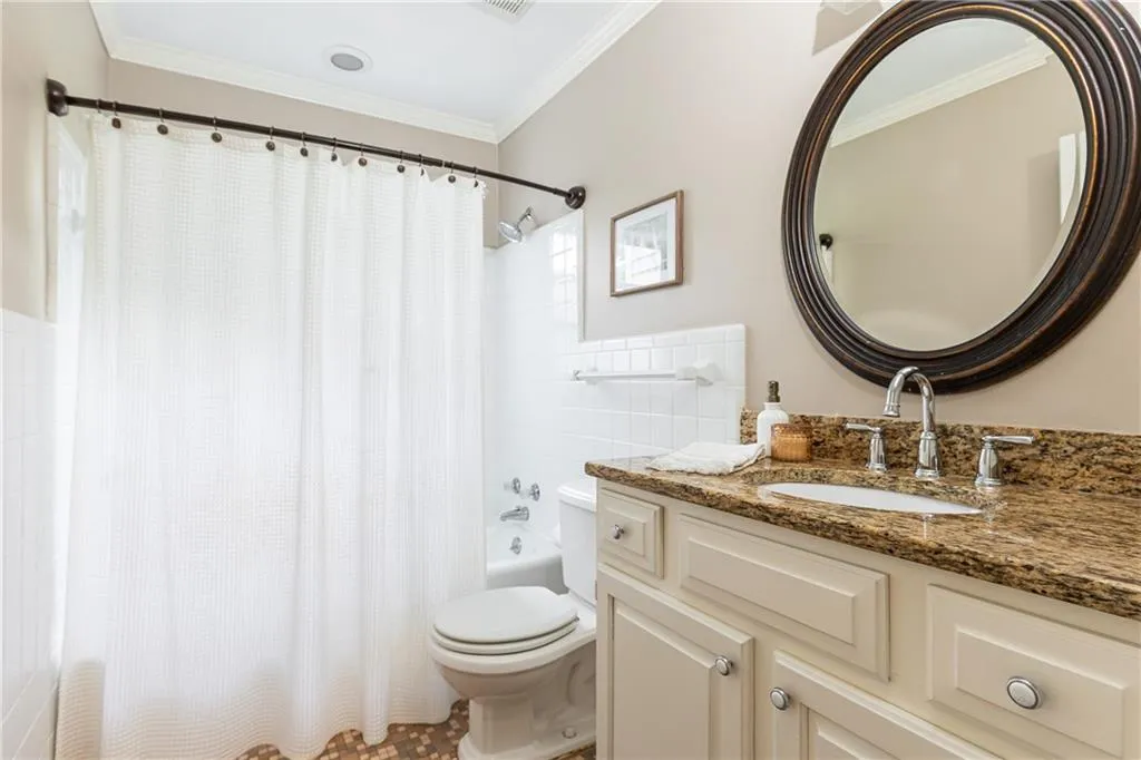 Bathroom featuring shower / tub combo with curtain, crown molding, and vanity