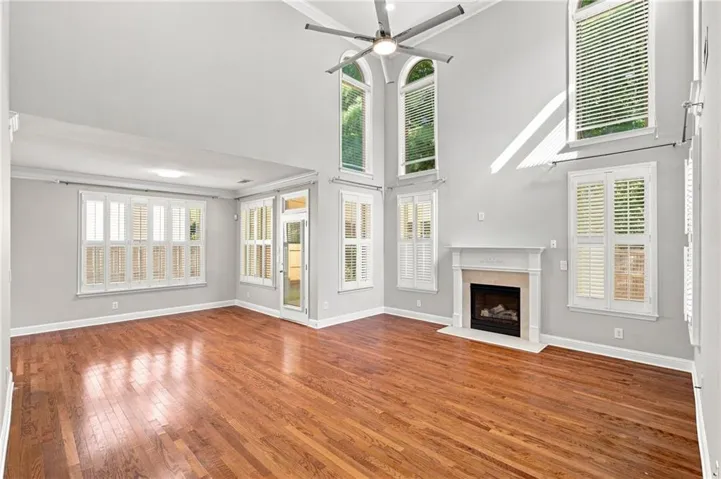 Wood-finish flooring throughout, with a classic fireplace and mantel