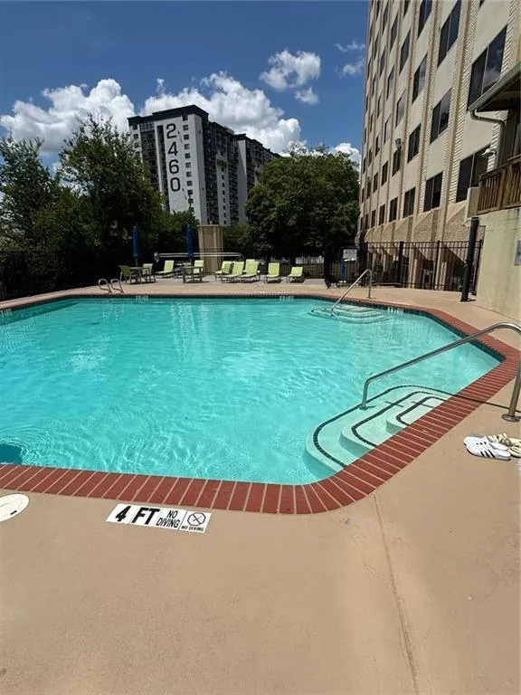 Community pool with a patio area
