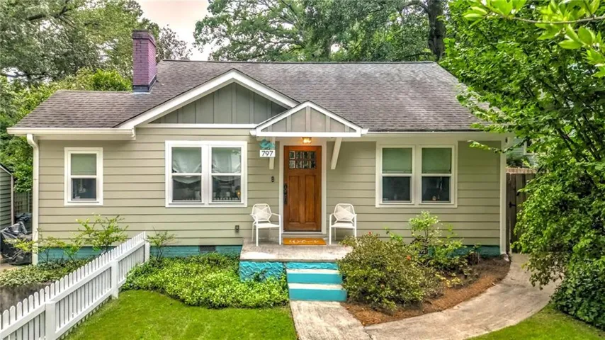 Craftsman-style exterior with horizontal siding, a gabled roof, and a prominent chimney