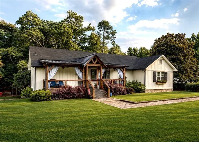Gabled architecture featuring a stone foundation and board and batten siding