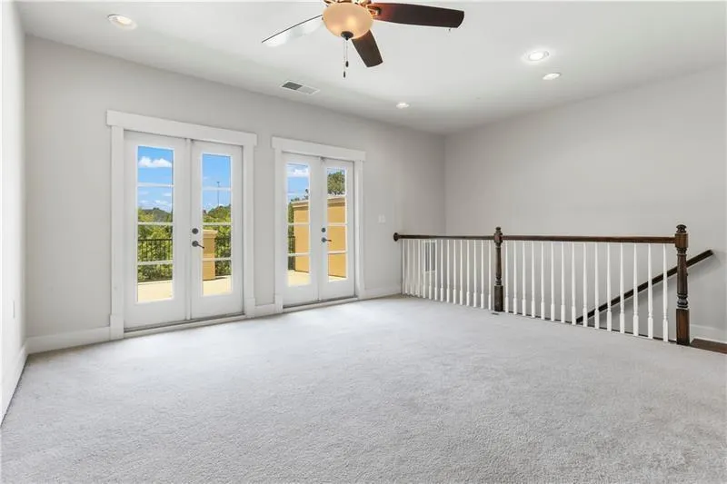 Carpeted empty room featuring recessed lighting, french doors, and ceiling fan