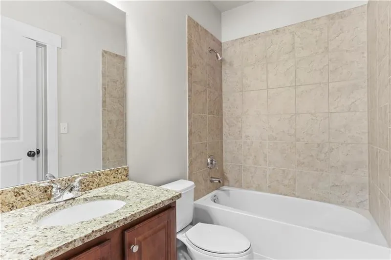 Full bath featuring shower / washtub combination and vanity