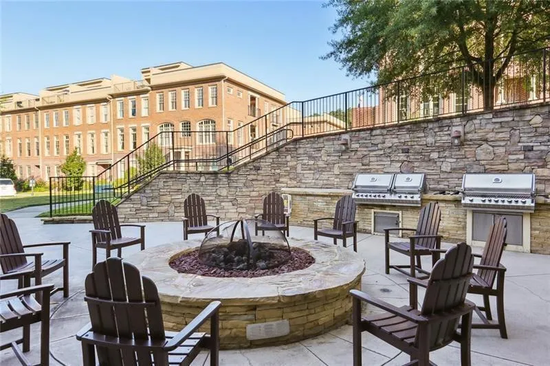 View of patio featuring an outdoor fire pit, area for grilling, and stairway