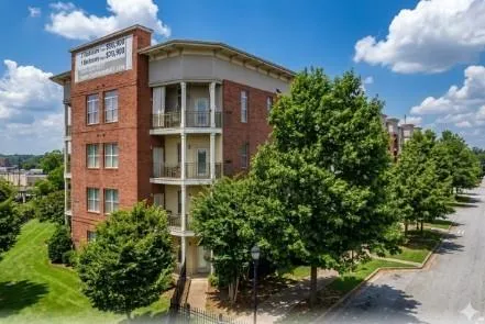 Brick exterior with balconies, multiple windows, and a street-facing orientation