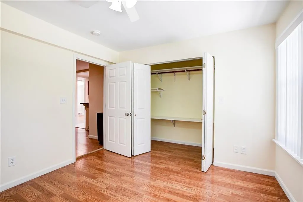 Unfurnished bedroom featuring a closet, light wood-type flooring, and ceiling fan
