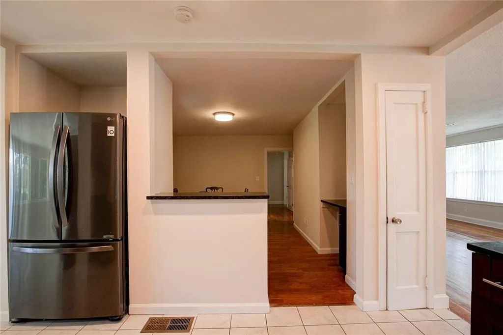 Kitchen featuring stainless steel fridge and light wood-type flooring