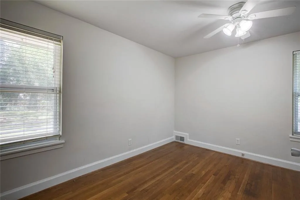 Unfurnished room with ceiling fan and wood-type flooring