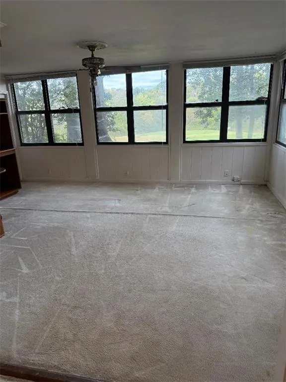 Empty room with light colored carpet