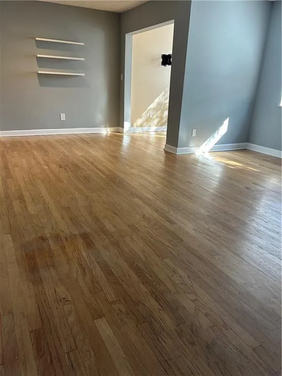 Empty room featuring light wood-type flooring and baseboards