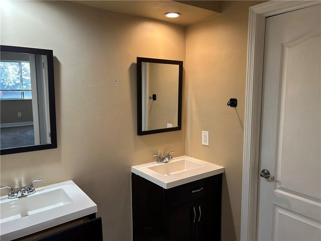 Full bath featuring two vanities and recessed lighting