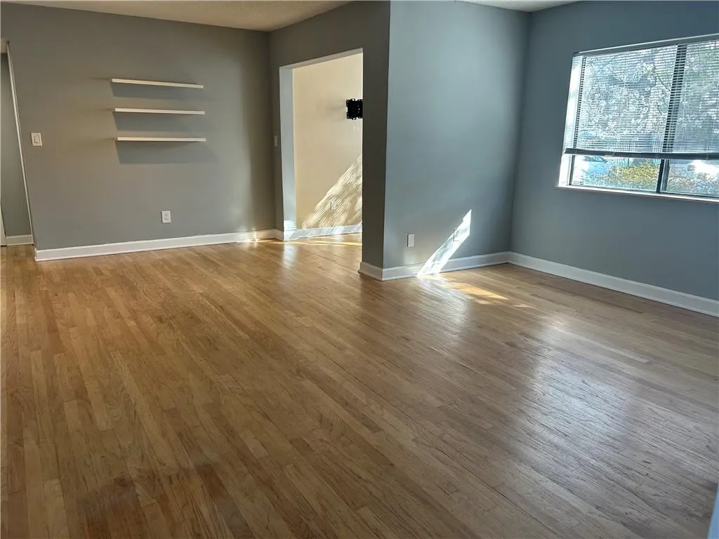 Spare room featuring light wood finished floors and a textured ceiling