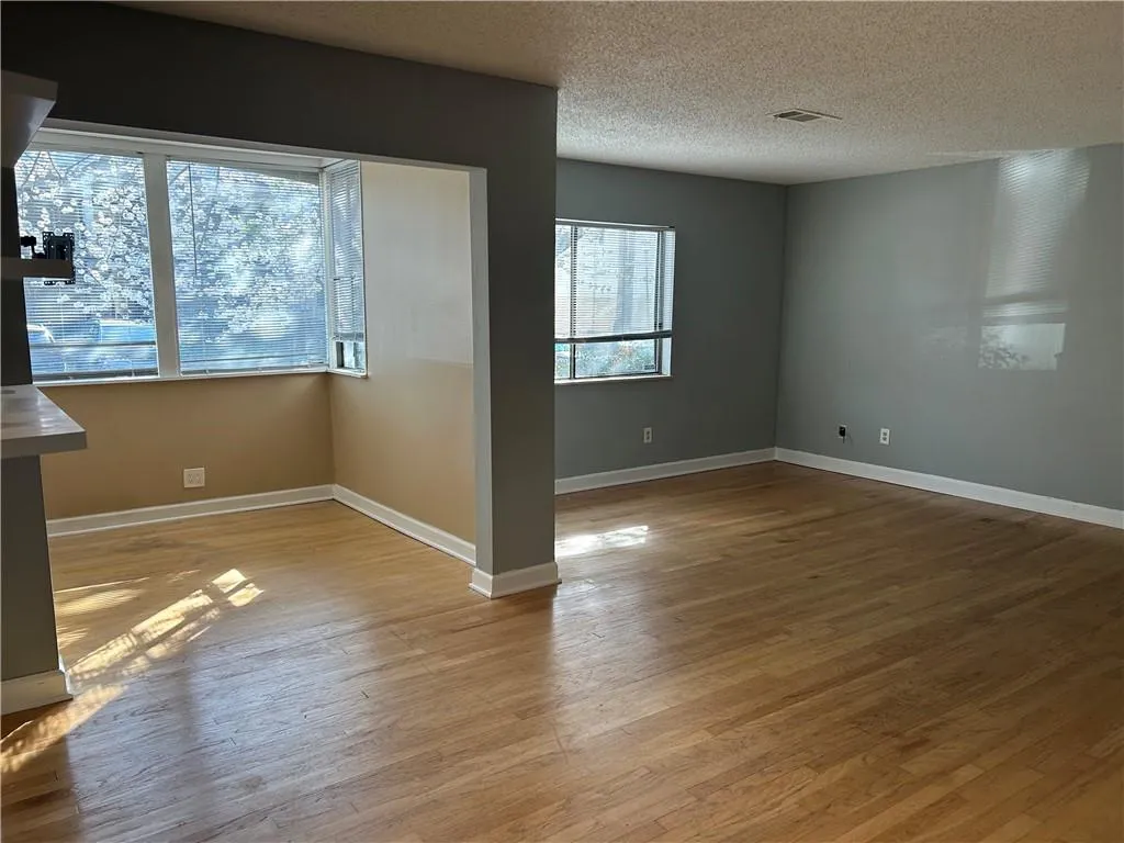 Spare room with light wood-style floors and a textured ceiling
