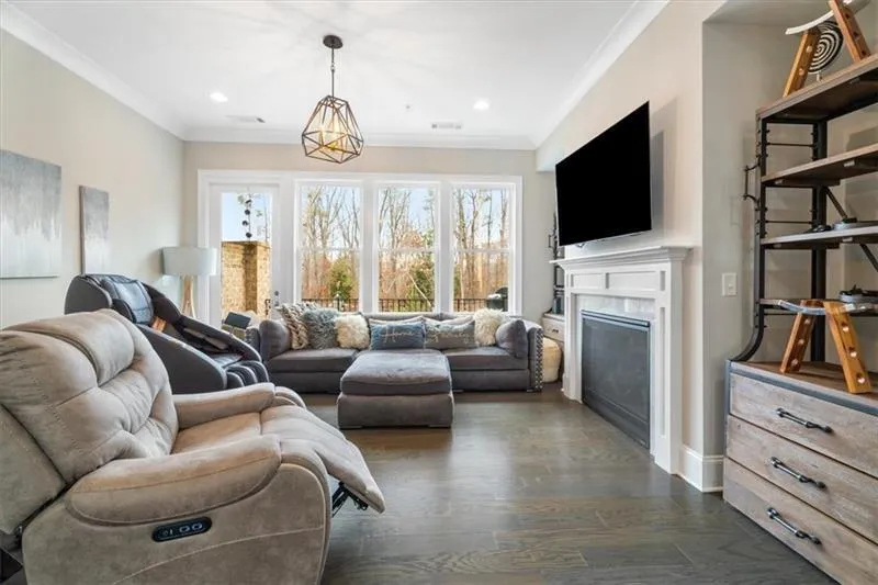 Living room with ornamental molding and dark hardwood / wood-style floors