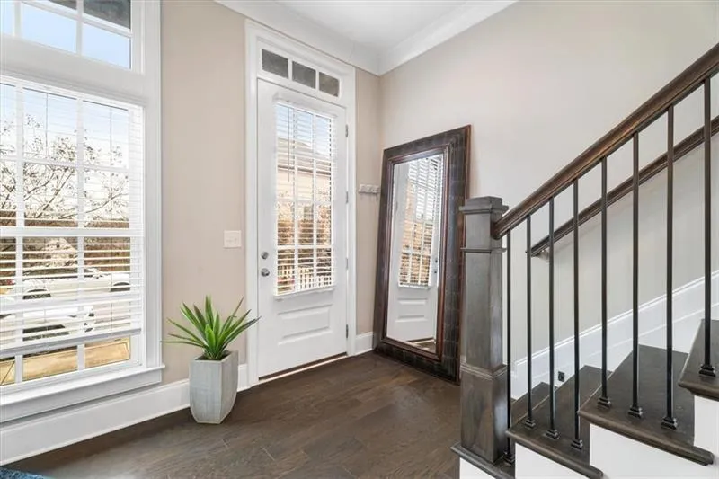 Foyer featuring dark hardwood / wood-style flooring and ornamental molding