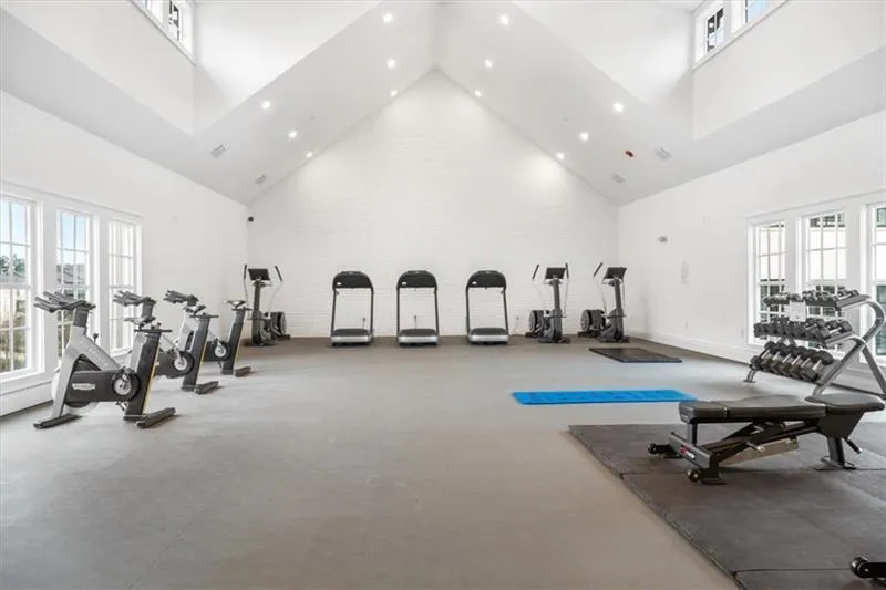 Workout area with high vaulted ceiling