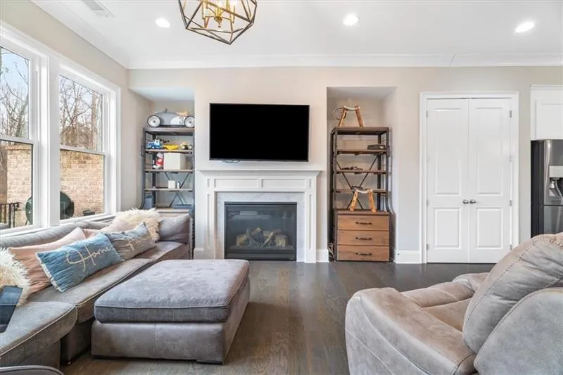 Living room featuring ornamental molding and dark wood-type flooring