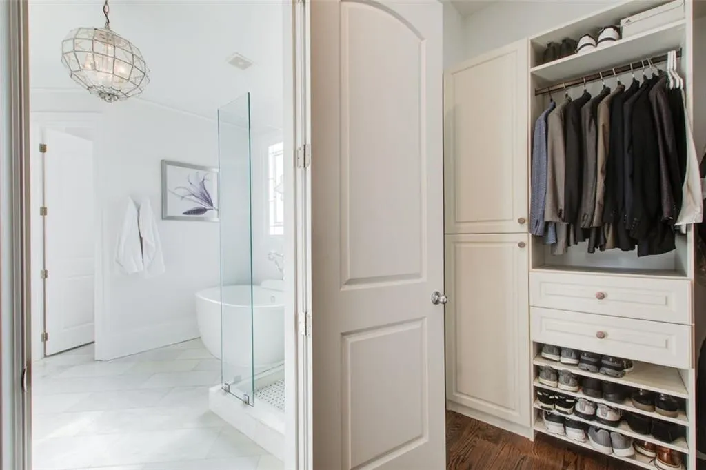 Primary bath leading into custom walk-in closet