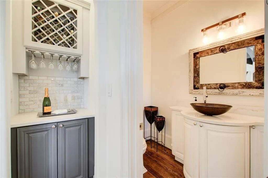 Bar with view into main level guest bath