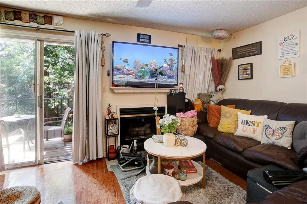 Living room featuring a textured ceiling and wood-type flooring